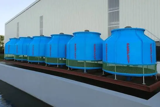 Row of blue FRP cross-flow cooling tower modules installed on an industrial cooling water basin