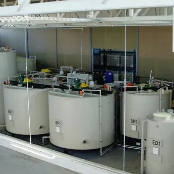 Industrial chemical storage and dosing tank skid with multiple vertical FRP tanks and piping