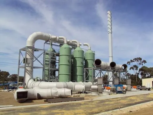 Industrial wet scrubber towers connected to FRP ductwork and an exhaust stack